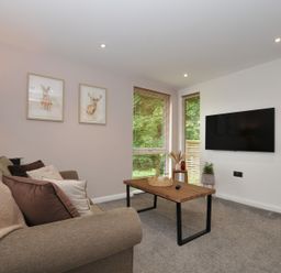 A living room with a sofa and coffee table at 24 Meadow Retreat in Dobwalls