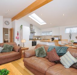 A living room with a kitchen area and dining table at 15 Faraway Fields in Dobwalls