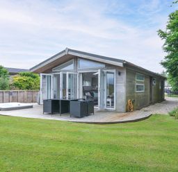 A house with a hot tub and decking in the garden at 1 Horizon View Dobwalls