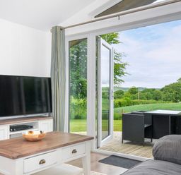 A living room with a television and a coffee table at 1 Horizon View in Dobwalls