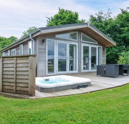 An outdoor area with a hot tub and seating at 1 Horizon View in Dobwalls