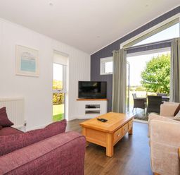 A living room with a sofa, coffee table and television at 3 Horizon View in Dobwalls