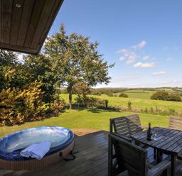 An outdoor area with a hot tub and a table with chairs at 8 Horizon View in Dobwalls