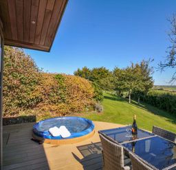 A garden with a hot tub and dining set at 10 Horizon View in Dobwalls