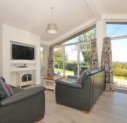 A living room with a television and two sofas at 10 Horizon View in Dobwalls