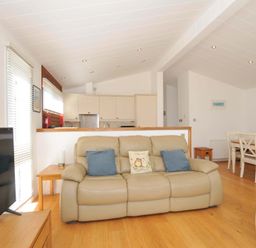 A living room with a sofa and a dining area at 11 Horizon View in Dobwalls