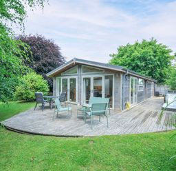 A garden with a wooden deck and chairs at 15 Horizon View in Dobwalls