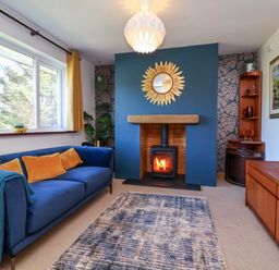 A living room with a fireplace and sofa at Hillsview in Combe Martin