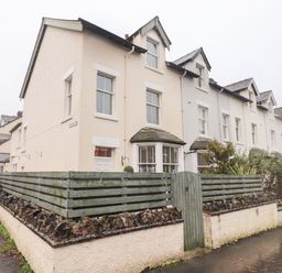 A row of terraced houses with wooden fences and small gardens at Blencathra in Keswick