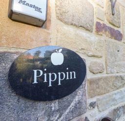 A sign reading Pippin on a stone wall at Pippin in Lucker