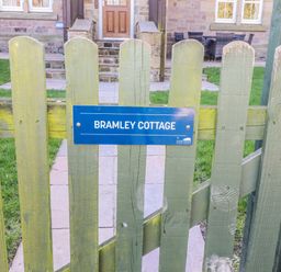 A gate with a sign at Bramley Cottage in Lucker
