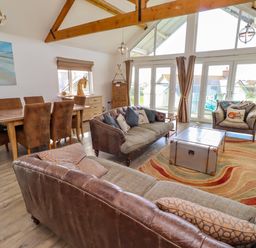A living room with seating and a dining area at Spindrifter in Beadnell