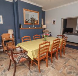 A dining room with a table and chairs at Number Seventeen Amble