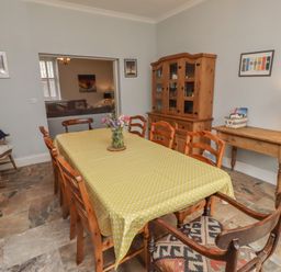 A dining room with a table and chairs at Number Seventeen Amble