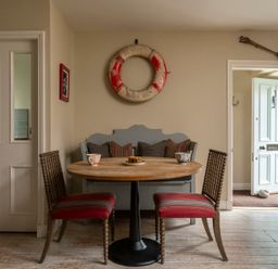 A dining room with a table and chairs at Sandpiper (Alnmouth)