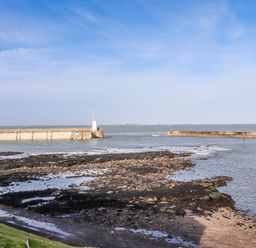 View of a pier and water at Cuddy's Holm in Seahouses