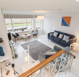 A living room with a sofa and coffee table at Dell Point in Beadnell