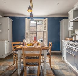 A kitchen with a dining table set at Westhill House in Warkworth