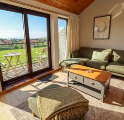 A living room with a sofa and coffee table at Links View in Embleton