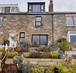 A house with plants and steps at Old Coastguard Cottages Amble