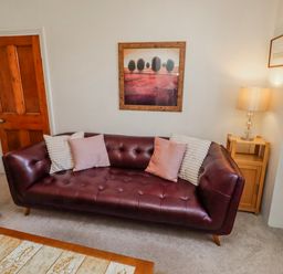A living room with a sofa and lamp at Hardys House in Alnwick