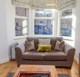 A living room with a sofa and coffee table at Alnbank in Alnmouth