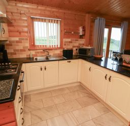 A kitchen with a sink and appliances at Heather Cottages - Brown Owl Bamburgh