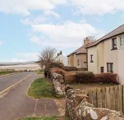 A street view with houses and a road at St Marys Cottages No4 Low Newton-by-the-Sea