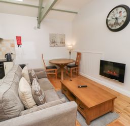 A living room with a sofa and coffee table at Chiff Chaff in Lucker