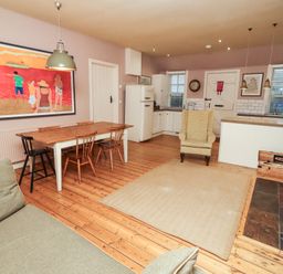 A kitchen with a dining table and chairs at Armstrong Cottages No6 Bamburgh