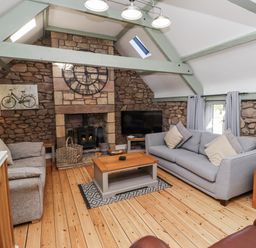 A living room with a sofa and fireplace at Millstone in Lucker