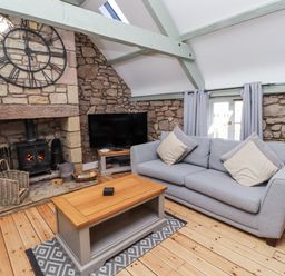 A living room with a sofa and fireplace at Millstone in Lucker