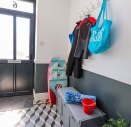 A hallway with a wetsuit and beach gear at Ty Haul in Rhosneigr