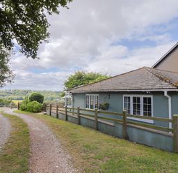 A house with a pathway and trees at Rainbow View in Churchstanton near Churchinford