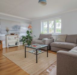 A living room with a sofa and coffee table at Rainbow View Churchstanton near Churchinford