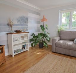 A living room with a plant and a chair at Rainbow View Churchstanton near Churchinford