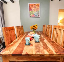 A dining room with a wooden table and chairs at 11- 13 High Street