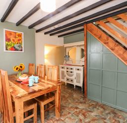 A dining room with a table and chairs at 11- 13 High Street