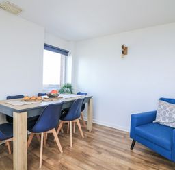 A dining room with a table and chairs at Sunset Sea View Chalet in Millbrook