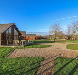 An outdoor area with lodges and a gravel path at Lodge 1 South Hykeham