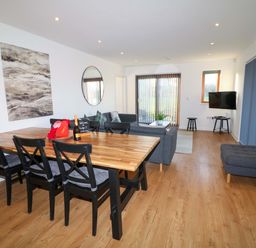 A living room with a dining table and sofa at Lodge 2 in South Hykeham