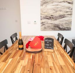A dining room with a table and champagne at Lodge 2 South Hykeham