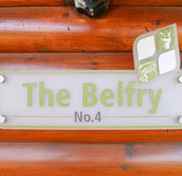 A wooden wall with a sign that says The Belfry No 4