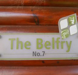 A sign on a wooden wall that reads The Belfry No 7 at Lodge 7 in South Hykeham