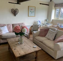 A living room with a couch and coffee table at The Bull Pen in Colyton