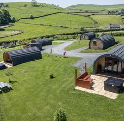 An outdoor area with cabins and hot tubs at Holly in Ulverston