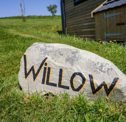 A rock with the name Willow in front of a building in Ulverston
