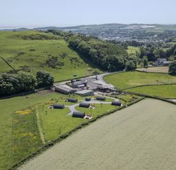 An aerial view of a farm surrounded by fields and hills at Willow in Ulverston