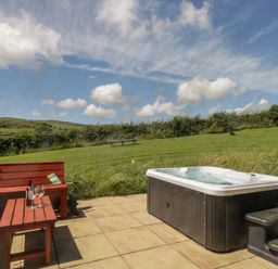 An outdoor area with a hot tub and seating at Oak in Ulverston