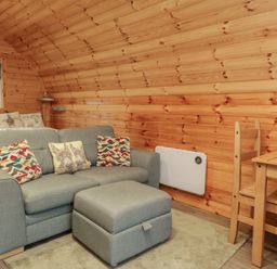 A living room with a sofa and a table at Rowan in Ulverston